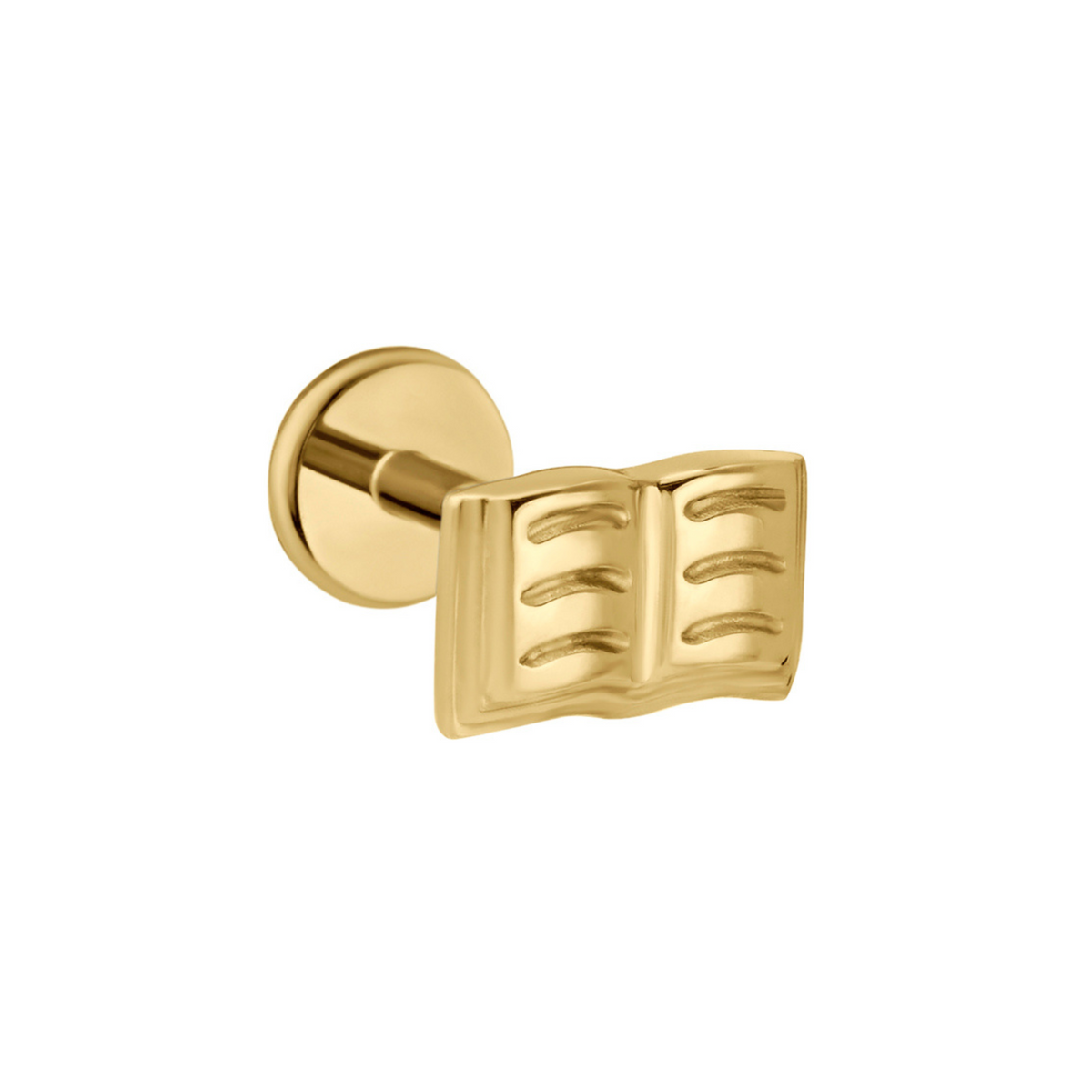Gold flat back stud that depicts and open book with lines on the pages. Against a white background.