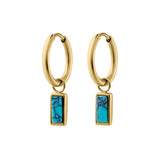 Gold hoop earrings with faux turquoise stone drops on a white background