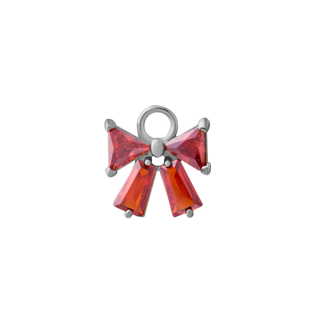 Silver bow-shaped charm with red gemstones on a white background