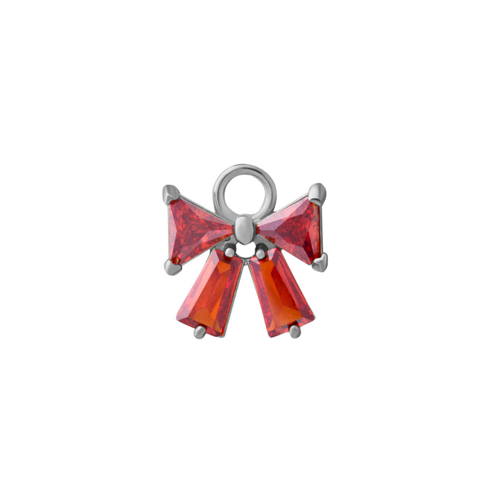 Silver bow-shaped charm with red gemstones on a white background