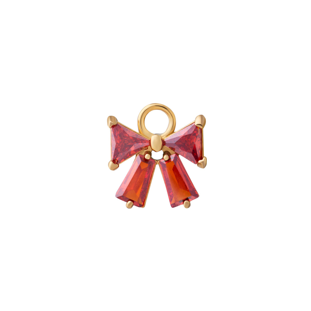 Gold bow-shaped charm with red gemstones on a white background