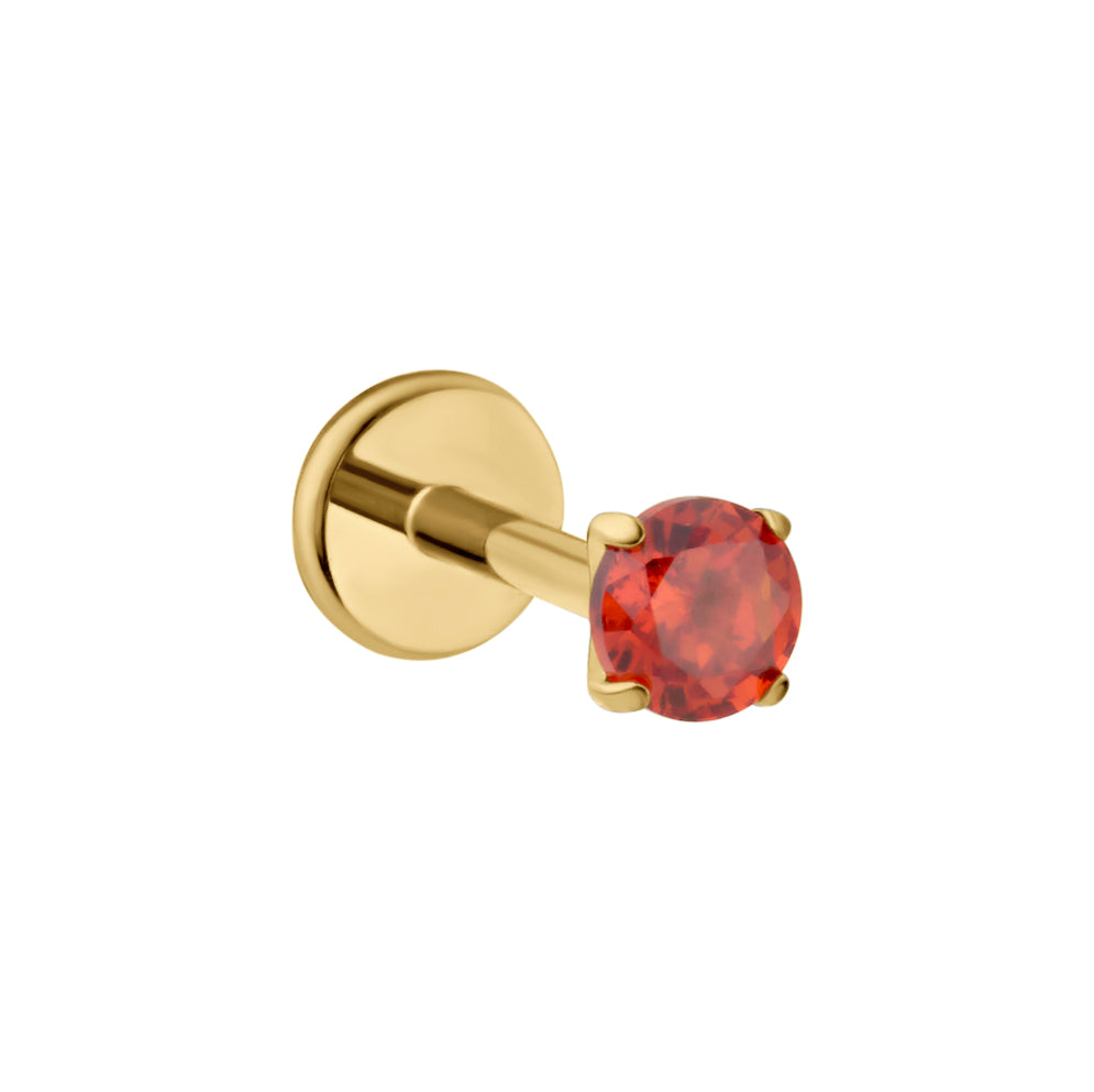 A gold-plated labret stud earring featuring a round-cut dark orange gemstone in a four-prong setting, shown against a plain white background.