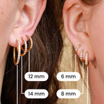 Comparison of 6 different sizes of gold hoops on the ears of 2 models.
