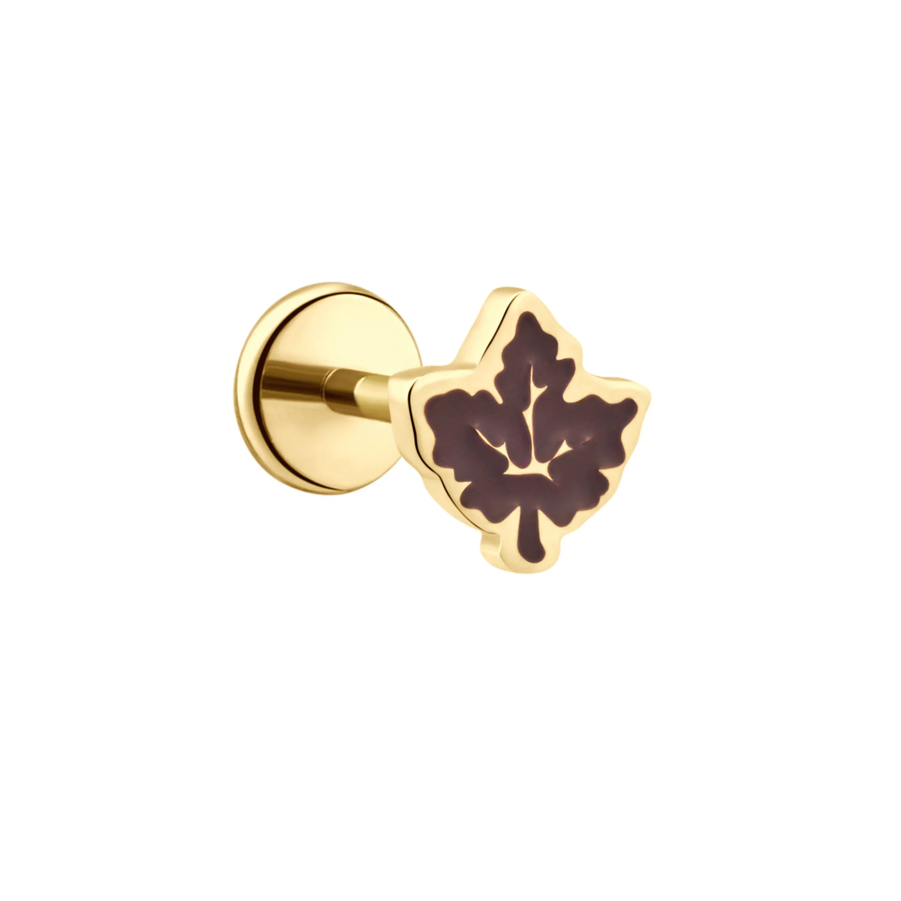 Close up of a gold flat back stud earring with a brown enamel maple leaf design on a white background