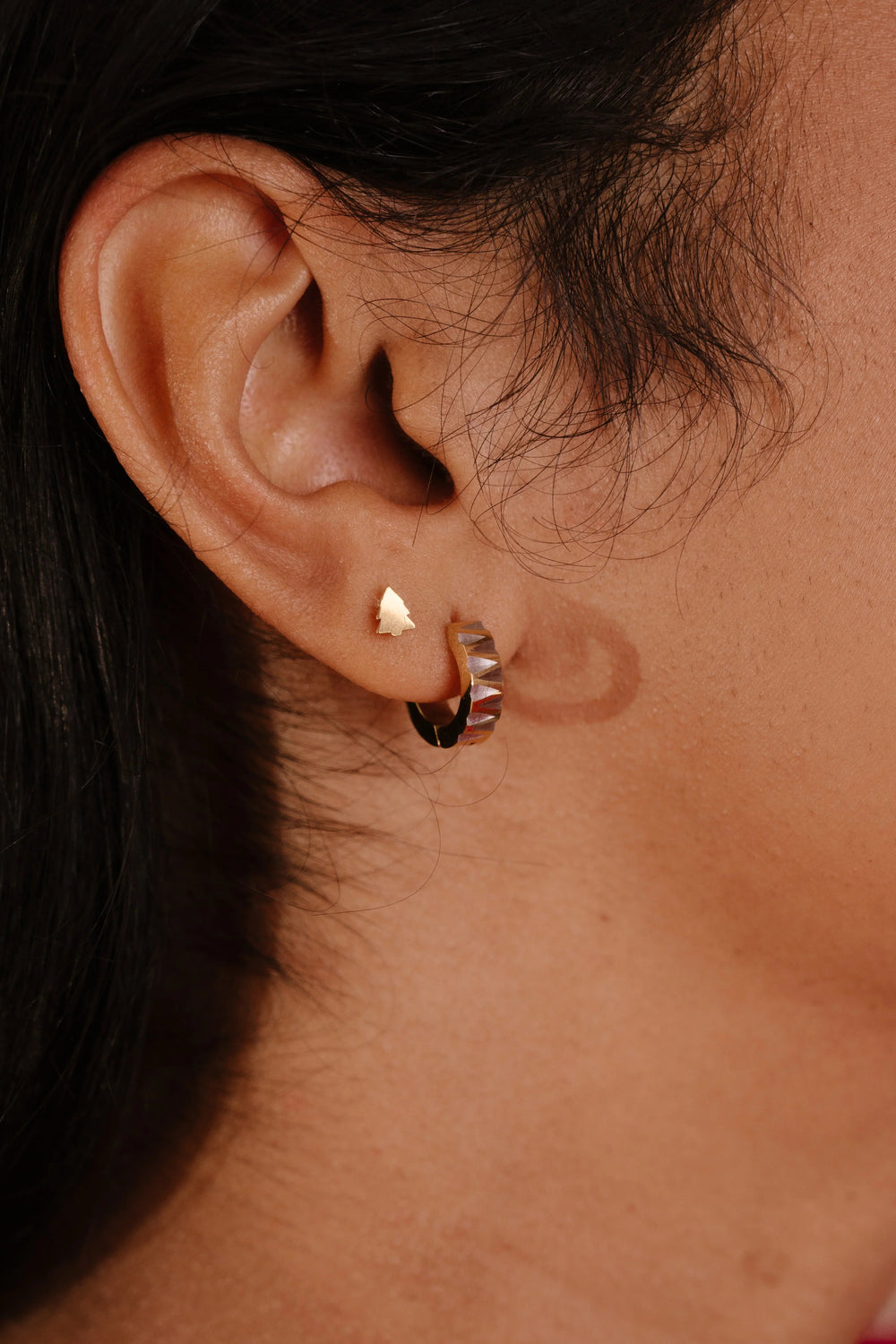 Close-up of an ear with a gold earring