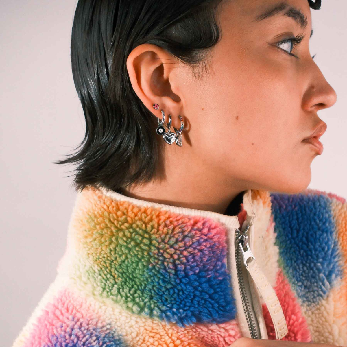 Person wearing multiple silver earrings