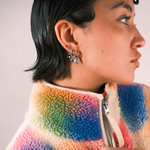 Person wearing multiple silver earrings