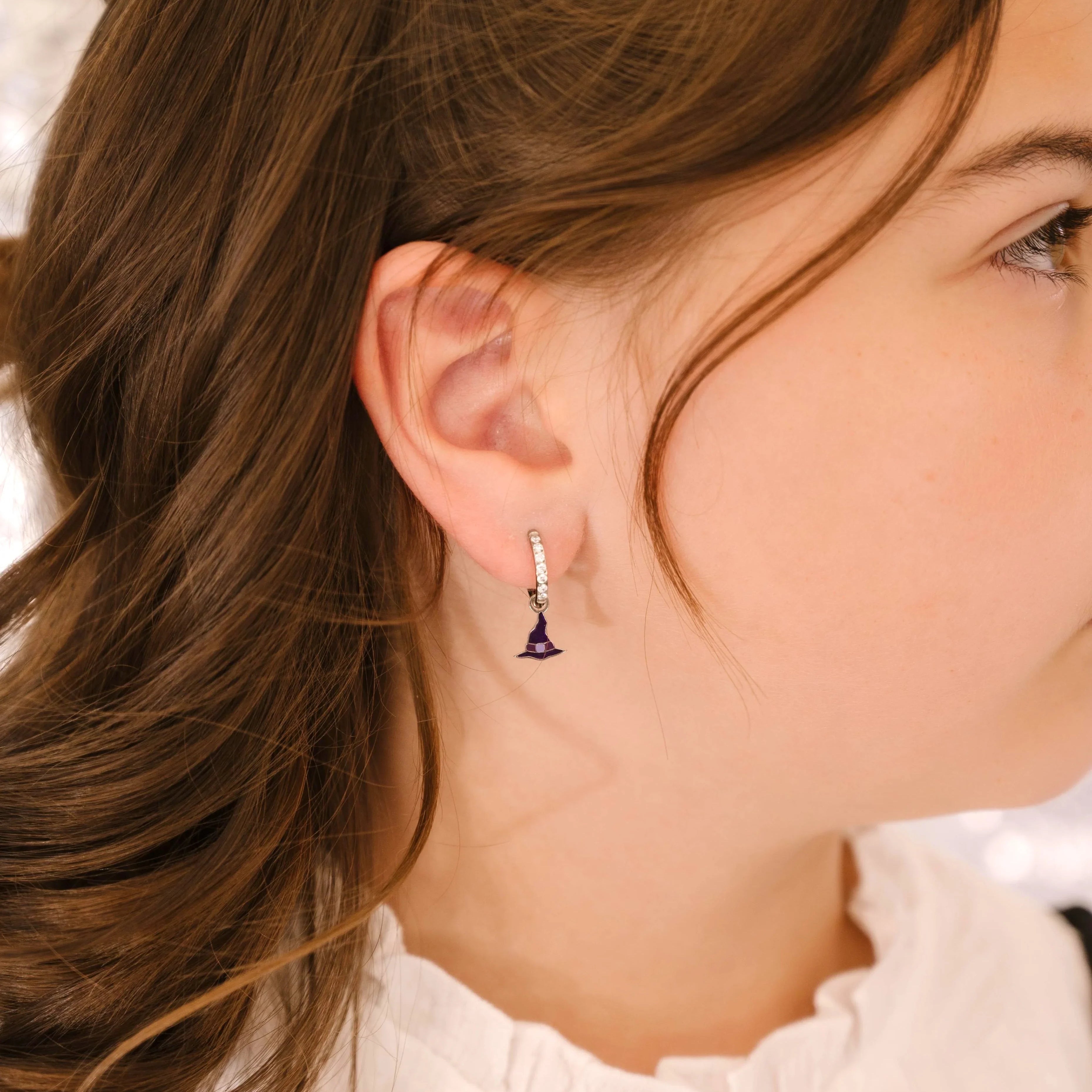 Close-up of a person wearing an earring with a blurred background