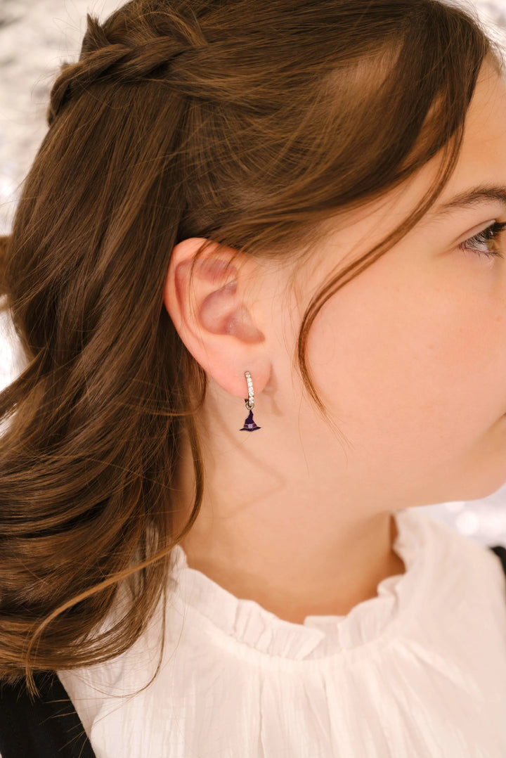 Close-up of a person wearing an earring with a blurred background