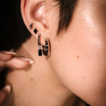 Silver and black earring stack featuring flat backs and hoop styles