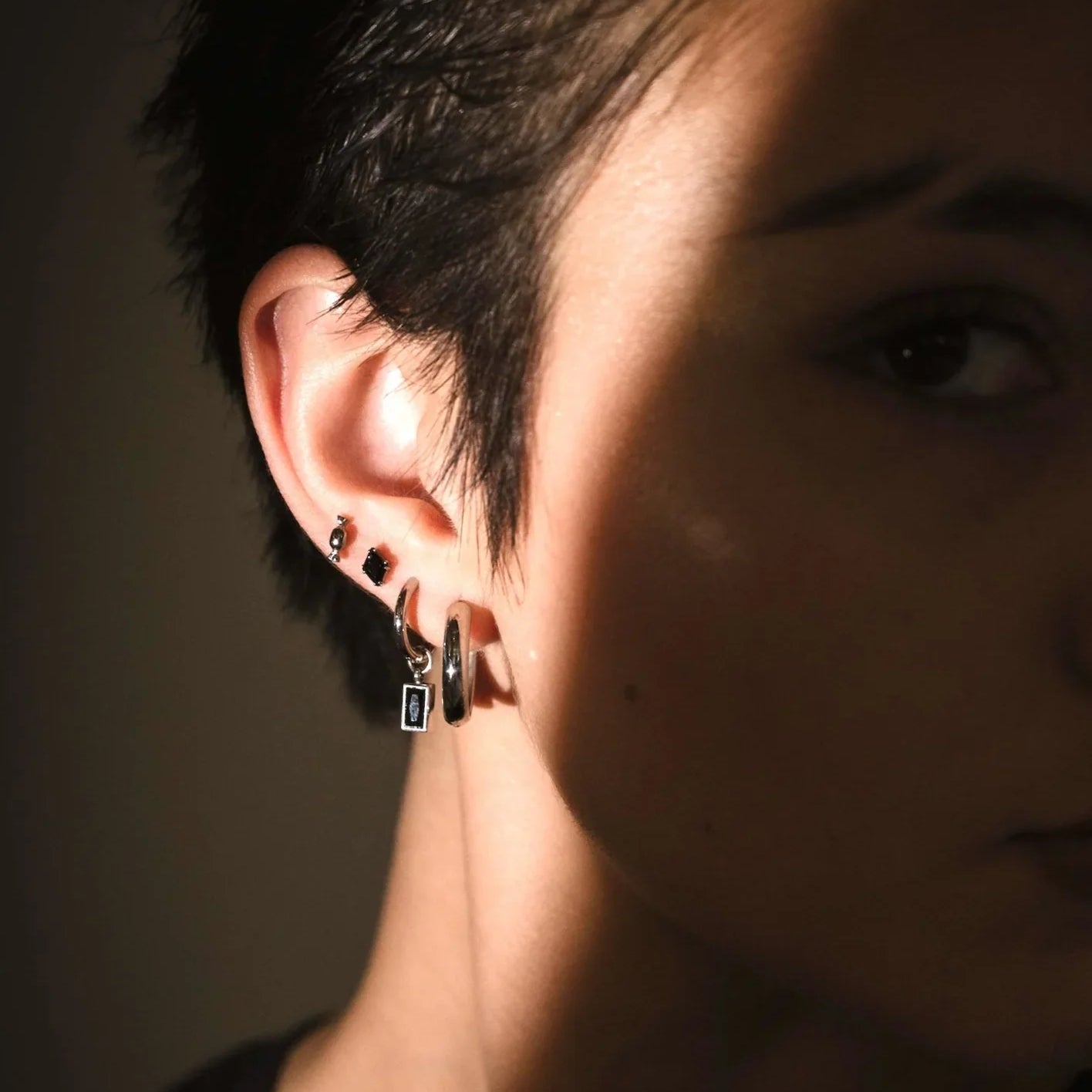 Model photo showcasing black and silver flat backs and hoops