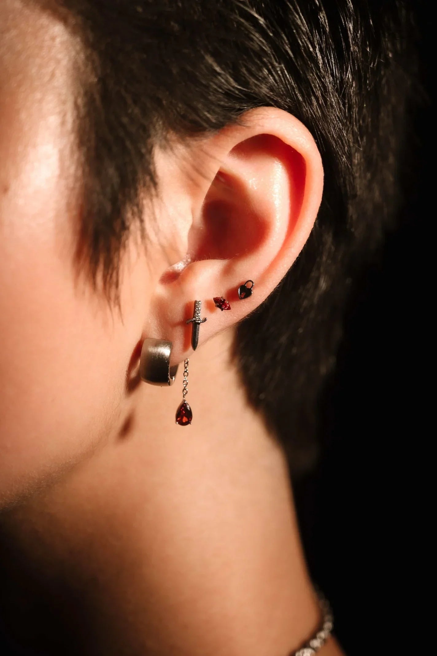 Silver and red earring stack on ear 