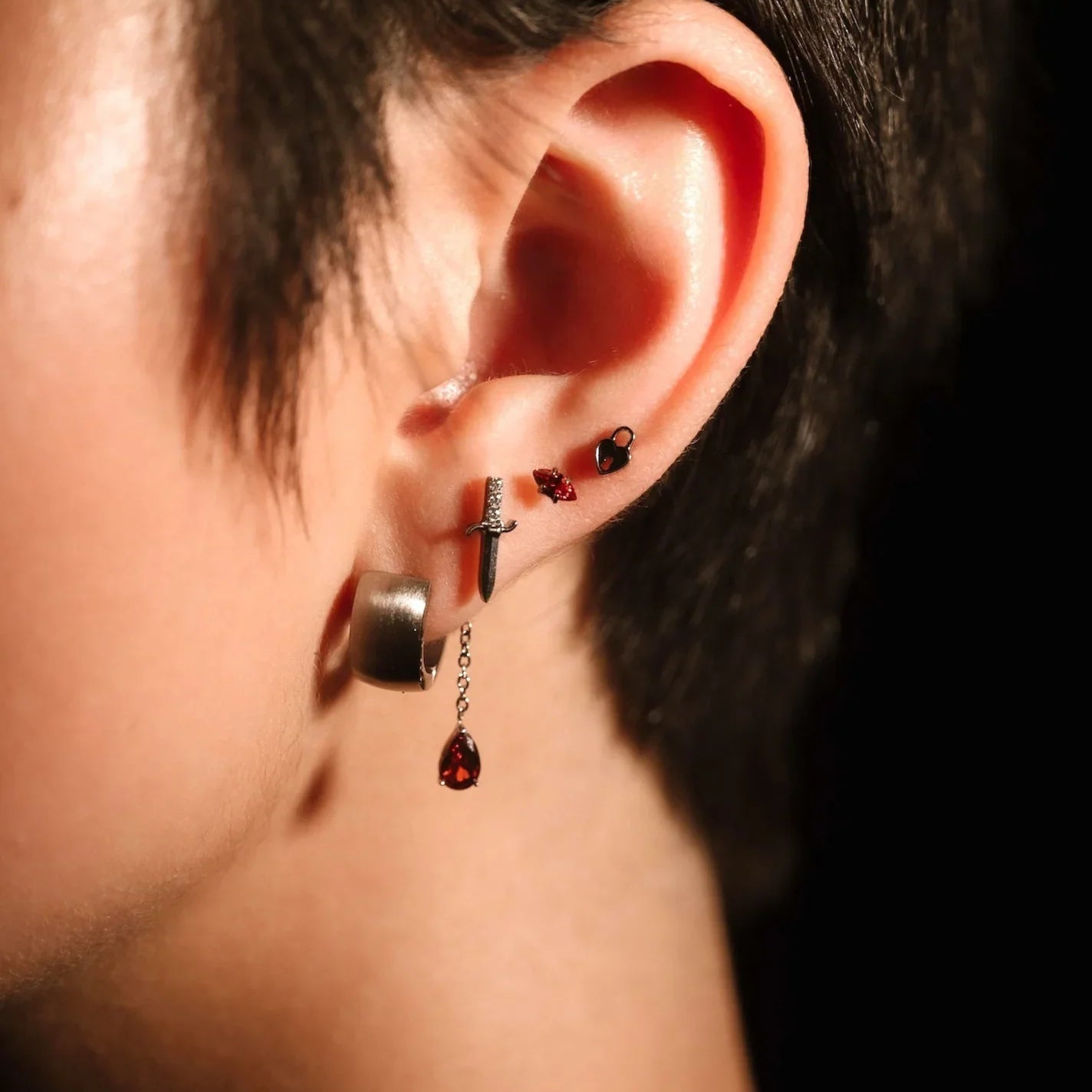 Silver and red earring stack on ear 
