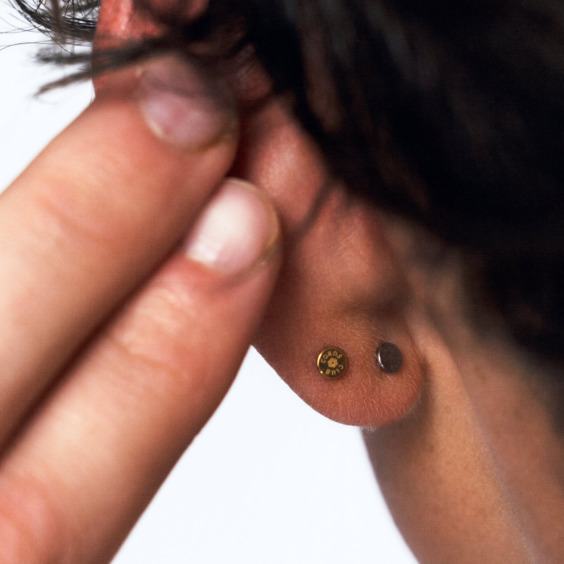 Close up of the back of someone's ear, showing how minimal and sleek that threadless labret flat back studs look. 
