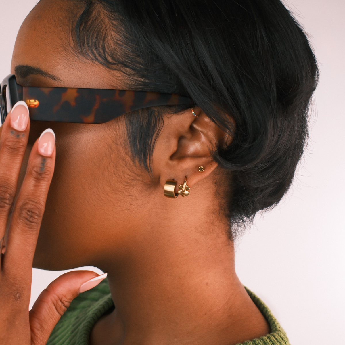 Woman wearing multiple gold earrings