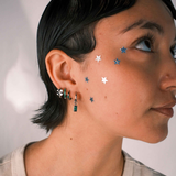 Close-up of an ear with multiple earrings 