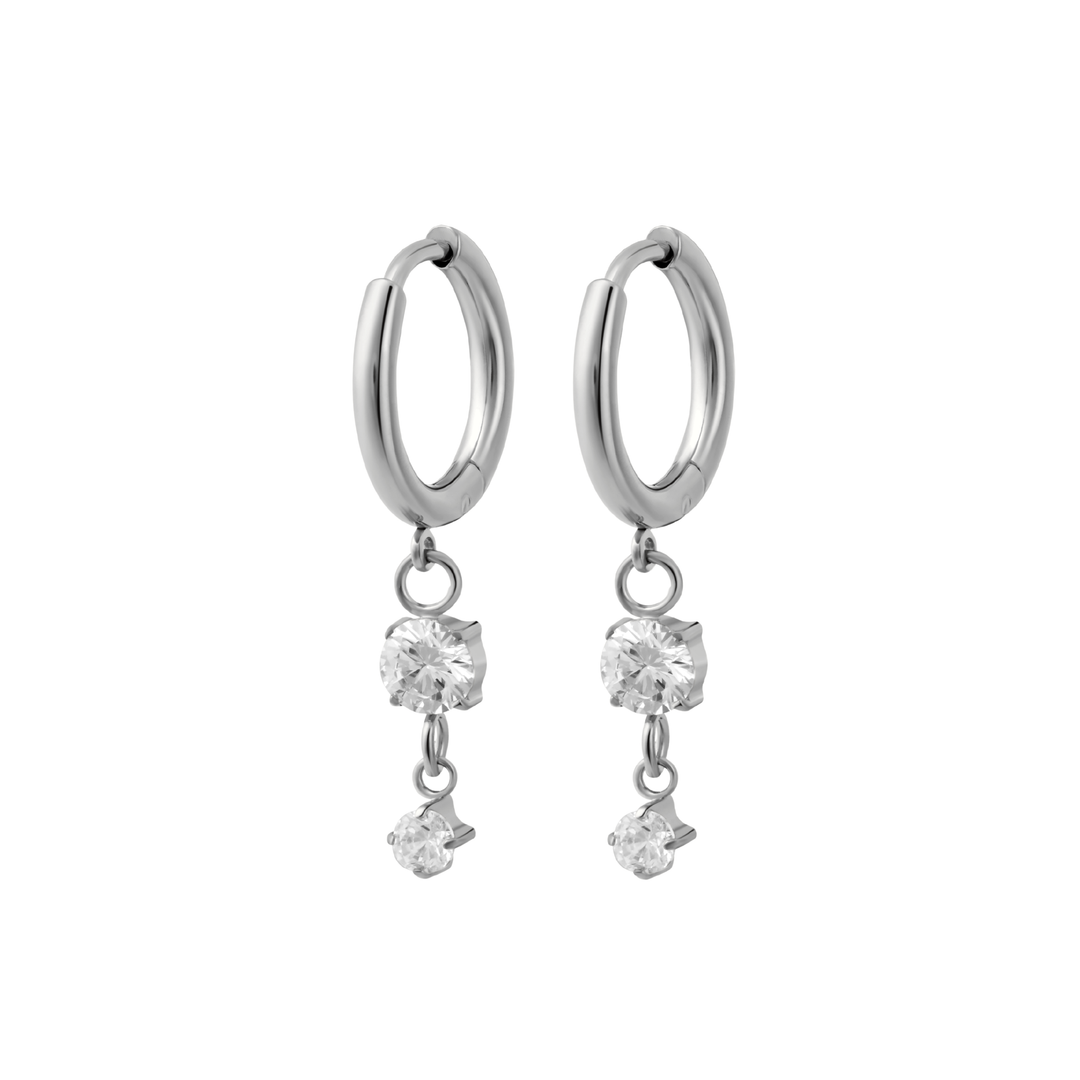 Silver hoop earrings with crystal drops on a white background