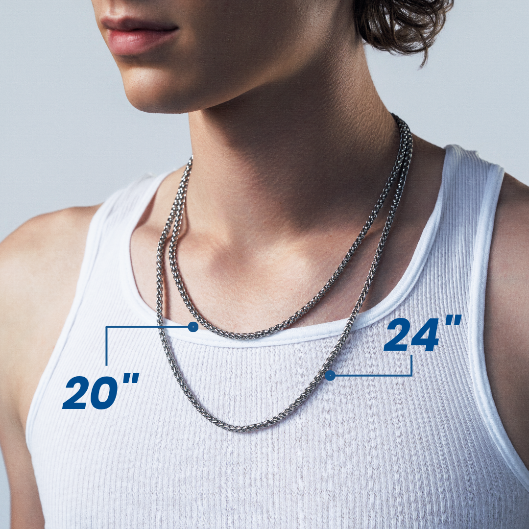 A close-up of a man wearing a silver chain necklace layered over a white ribbed tank top, with blue measurement callouts showing 20 inches and 24 inches, and text reading 'Multiple Lengths for a customized look'.