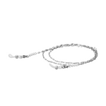 A coiled silver glasses chain with freshwater pearl beads and silicone loops on the end on a white background.