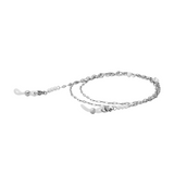 A coiled silver glasses chain with freshwater pearl beads and silicone loops on the end on a white background.