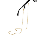Gold eyeglass chain attached to black sunglasses on a white background