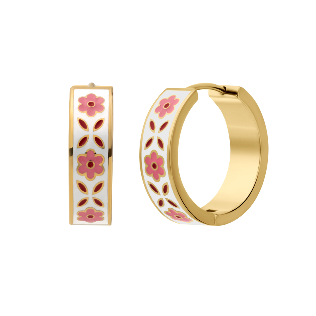 A close up of a hoop earring made from gold-plated titanium metal, with folk-art style floral patterns in pink, dark pink, and white enamel.