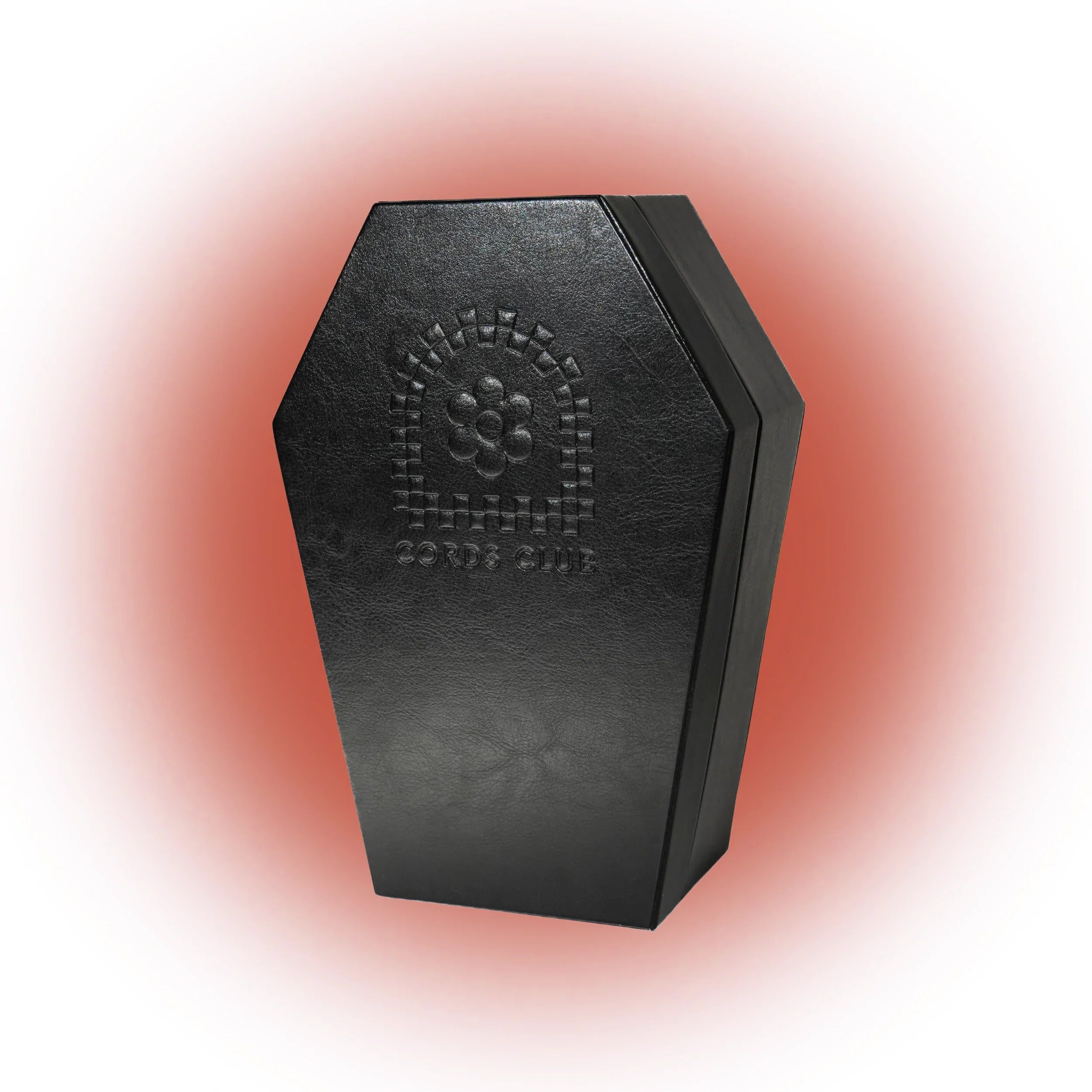 Black coffin-shaped box with embossed design on a gradient background
