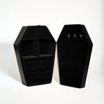 Black coffin-shaped jewelry box on a white background