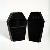 Black coffin-shaped jewelry box on a white background