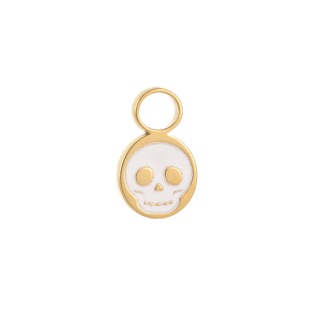 Gold hoop charm with a white enamel skull design on a white background