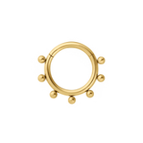 Close up of a clicker-style hoop featuring a series of round metal details that radiate from the main hoop. Designed for Daith or Septum piercings, and made from ASTM F136 Implant-Grade Titanium, finished with 18K Gold PVD plating