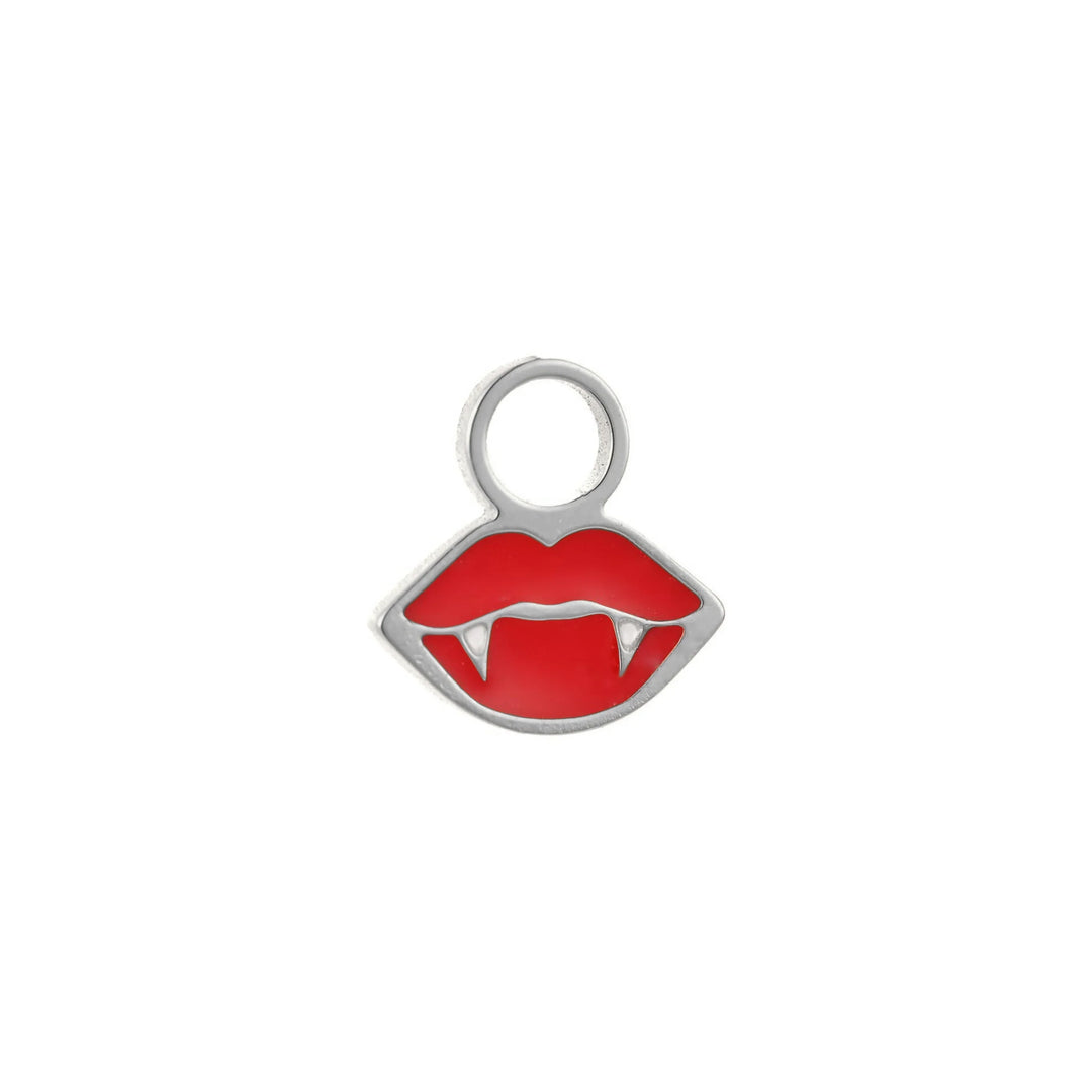 Lip-shaped red enamel charm with vampire fangs on a white background