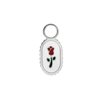 Small oval charm with a red rose design on a white background