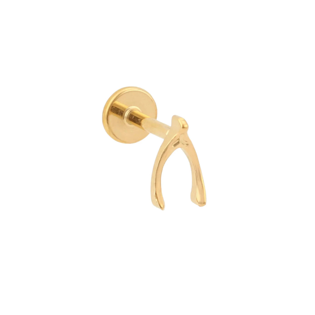 A single gold-colored titanium flat back stud in the shape of a wishbone, displayed against a white background.