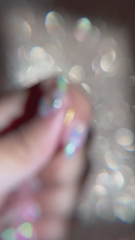 Close up, macro video of gold sardine-shaped flat back labret stud. No sound in video.